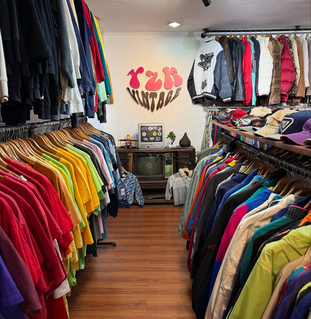 Colourful shirts and clothing inside Y2K Vintage store